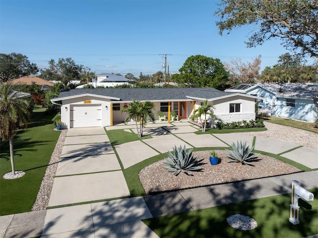 ranch-style house featuring a garage and a front yard