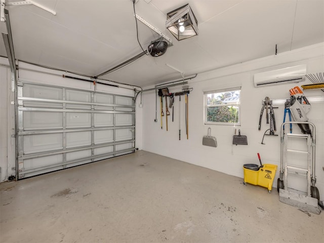 garage with a garage door opener and a wall mounted AC