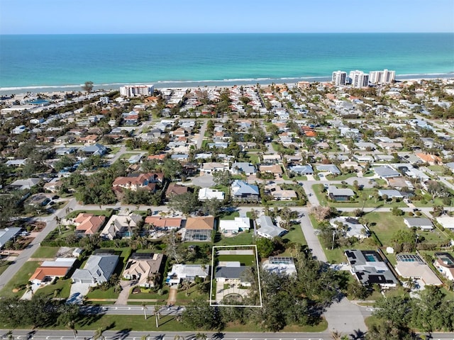 birds eye view of property featuring a beach view and a water view