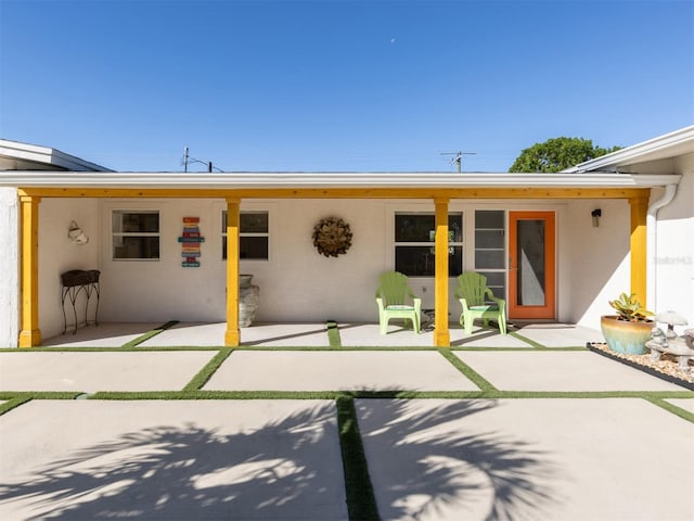 back of property with a patio