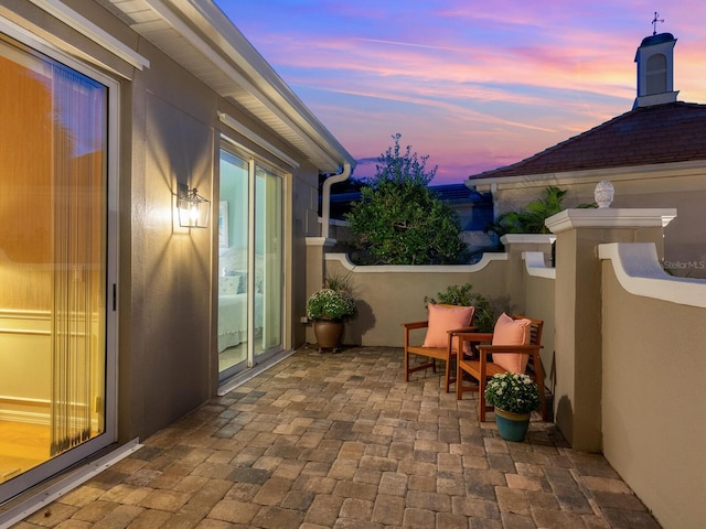 view of patio terrace at dusk