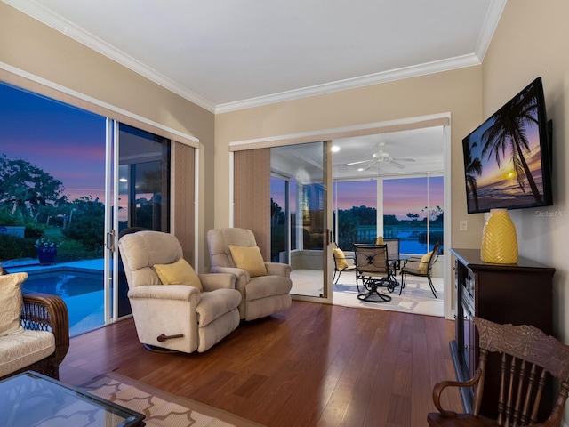 living area with crown molding, ceiling fan, and hardwood / wood-style flooring