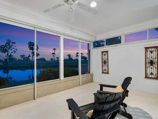 workout area with carpet flooring, ceiling fan, and a water view