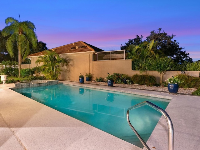 view of pool at dusk