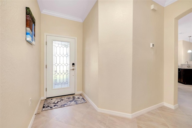 foyer featuring crown molding and light tile patterned floors