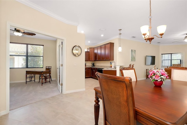 dining room with ceiling fan with notable chandelier, light colored carpet, crown molding, and a healthy amount of sunlight