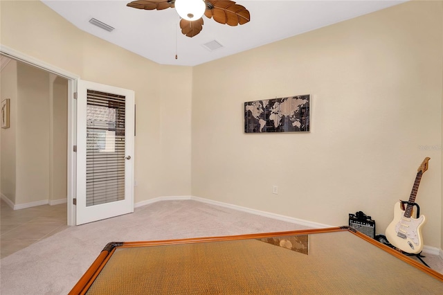 unfurnished bedroom with ceiling fan and light colored carpet