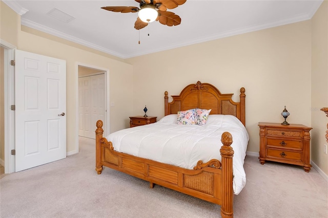 carpeted bedroom with ceiling fan, a closet, and ornamental molding