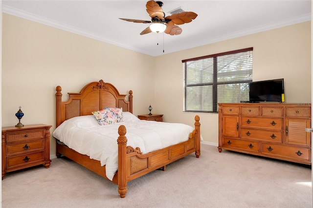 carpeted bedroom featuring ceiling fan and crown molding