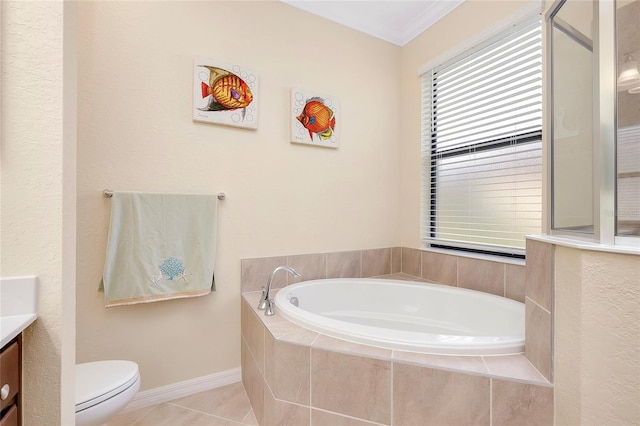 bathroom featuring tile patterned floors, tiled tub, crown molding, toilet, and vanity