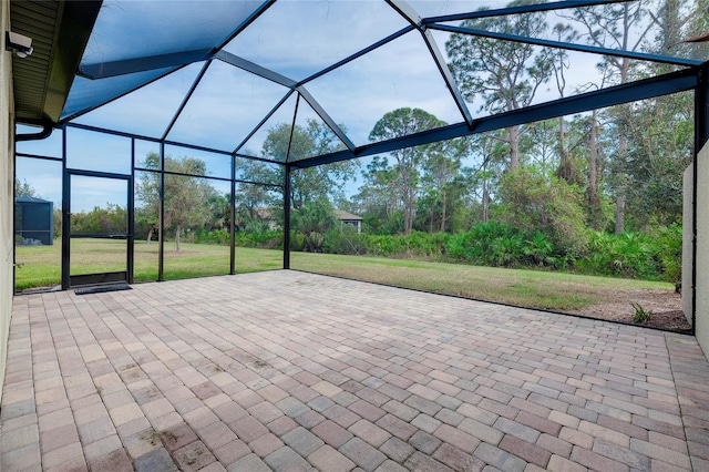 view of patio featuring glass enclosure