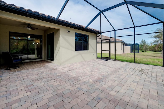 view of patio featuring a lanai and ceiling fan