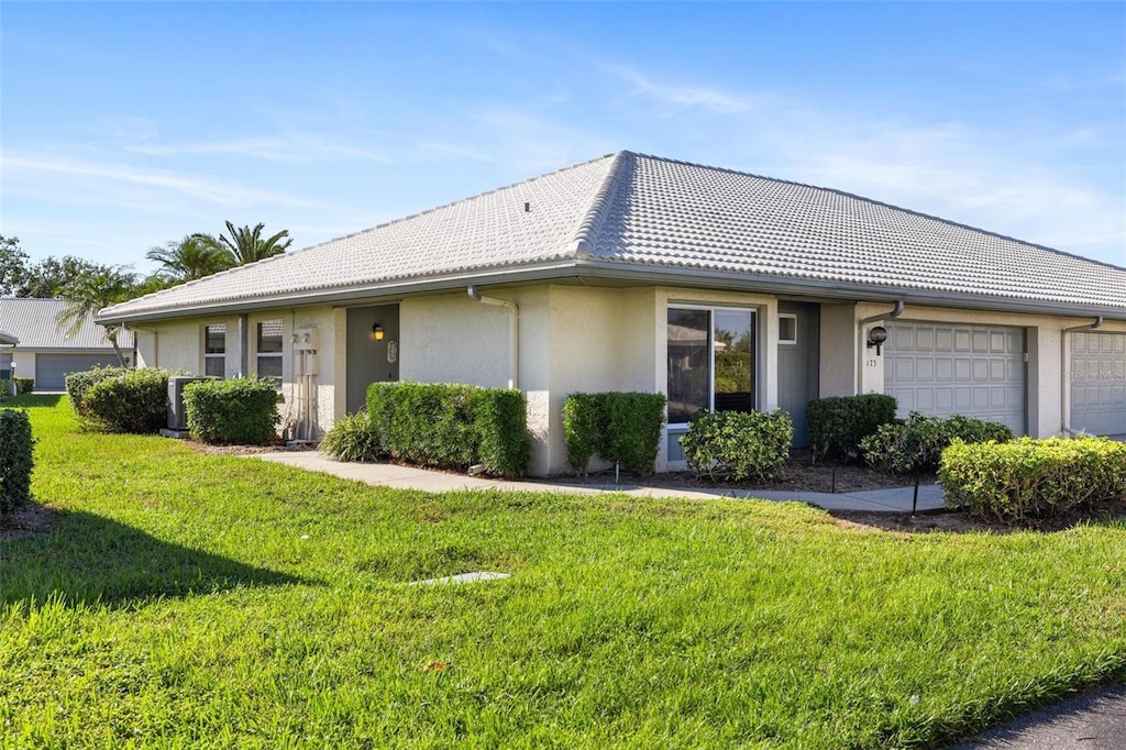 ranch-style home with a front yard and a garage