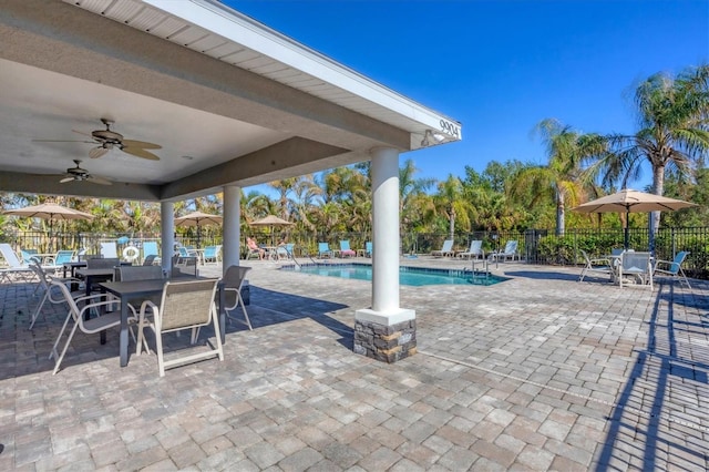 view of patio / terrace with ceiling fan and a community pool