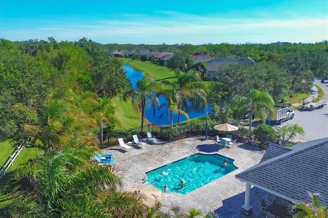 view of pool with a patio and a water view