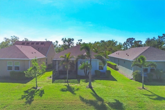 back of house with a lawn