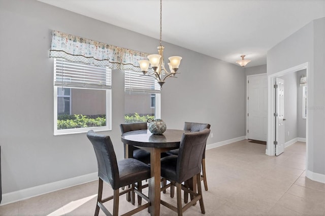 tiled dining space with an inviting chandelier