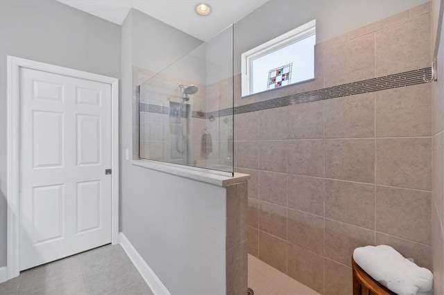 bathroom featuring tile patterned floors and tiled shower