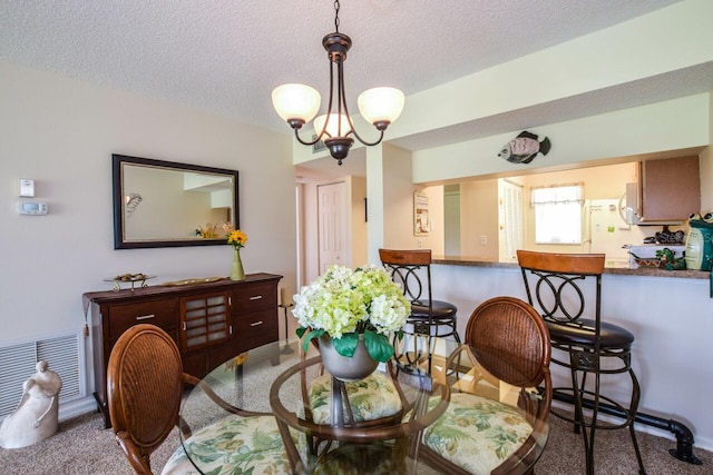 dining room featuring a notable chandelier and a textured ceiling