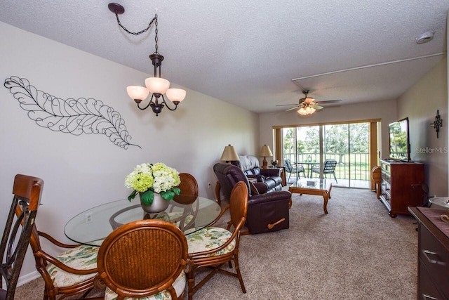 dining room featuring a textured ceiling, ceiling fan, and light carpet