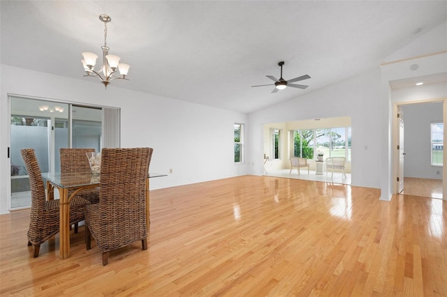 unfurnished dining area with ceiling fan with notable chandelier, light hardwood / wood-style flooring, plenty of natural light, and lofted ceiling