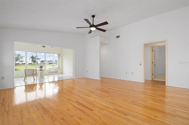 unfurnished living room featuring ceiling fan, high vaulted ceiling, and light hardwood / wood-style flooring