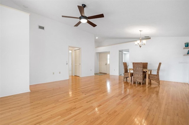 dining room with light hardwood / wood-style flooring, high vaulted ceiling, and ceiling fan with notable chandelier