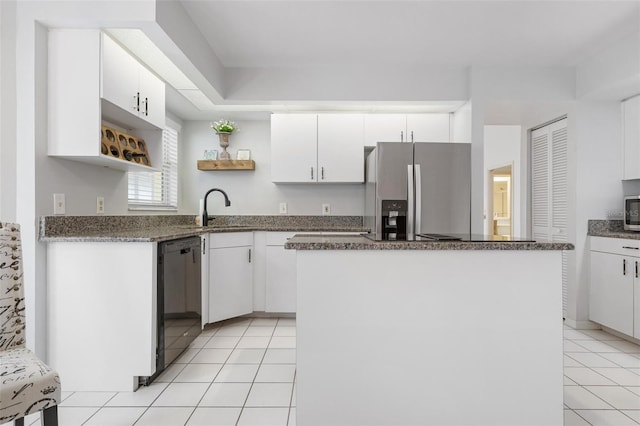 kitchen featuring sink, black dishwasher, white cabinets, stainless steel refrigerator with ice dispenser, and a kitchen island