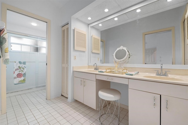 bathroom featuring a textured ceiling, vanity, and tile patterned floors