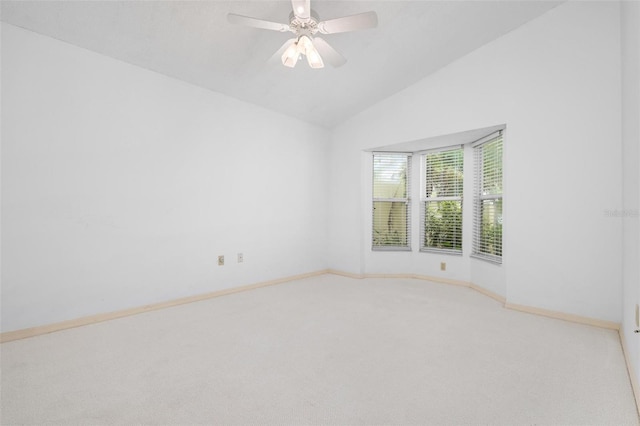 carpeted empty room featuring ceiling fan and vaulted ceiling