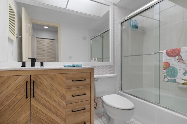 full bathroom featuring tile patterned flooring, vanity, enclosed tub / shower combo, and toilet