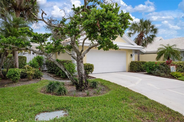 view of front of house with a front yard and a garage