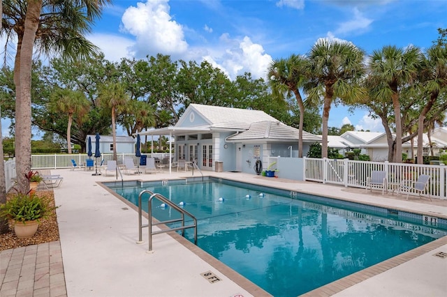 view of swimming pool with an outbuilding and a patio area