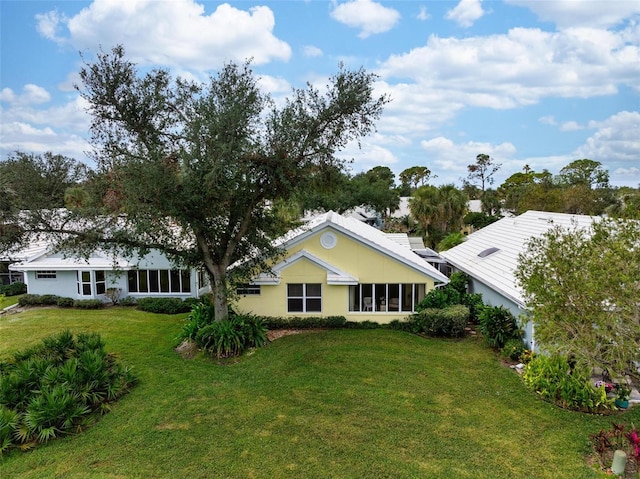 rear view of property featuring a yard