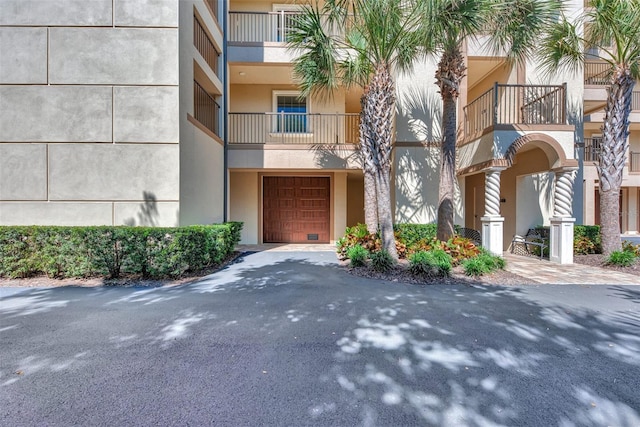 830 The Esplanade N Unit 203, Venice, FL 34285 - view of property featuring a garage and driveway
