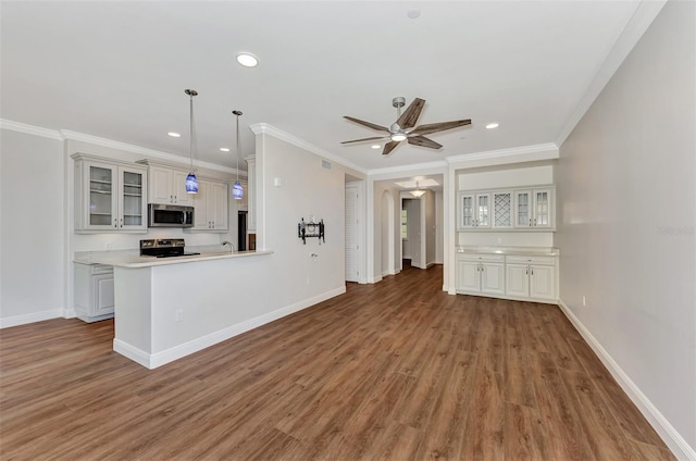 unfurnished living room with hardwood / wood-style floors, ceiling fan, and ornamental molding