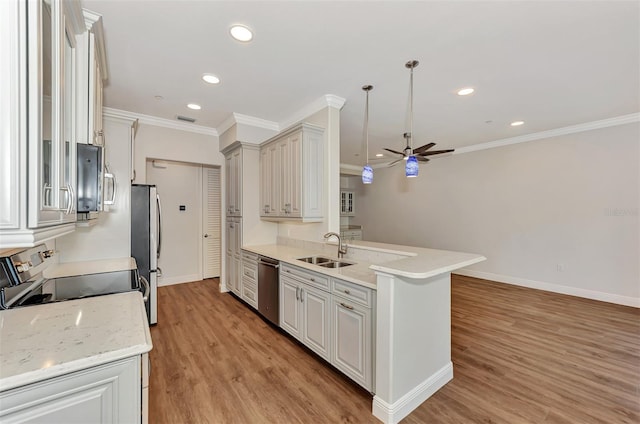 kitchen featuring stainless steel appliances, ceiling fan, sink, decorative light fixtures, and light hardwood / wood-style floors