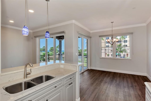 kitchen with white cabinets, light stone countertops, sink, and dark wood-type flooring