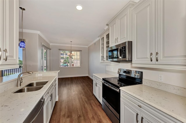 830 The Esplanade N Unit 203, Venice, FL 34285 - kitchen featuring stainless steel appliances, a sink, dark wood finished floors, white cabinets, and light stone countertops