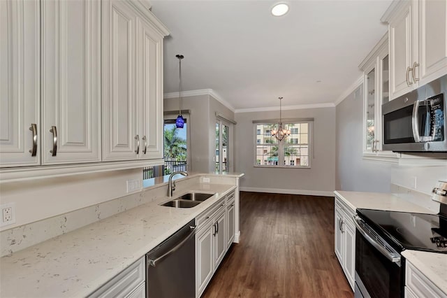 kitchen with appliances with stainless steel finishes, dark hardwood / wood-style flooring, sink, pendant lighting, and an inviting chandelier