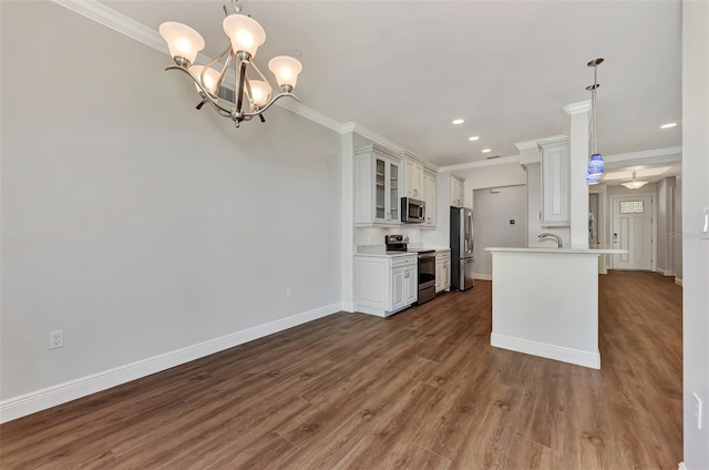 kitchen with white cabinets, appliances with stainless steel finishes, decorative light fixtures, and dark wood-type flooring