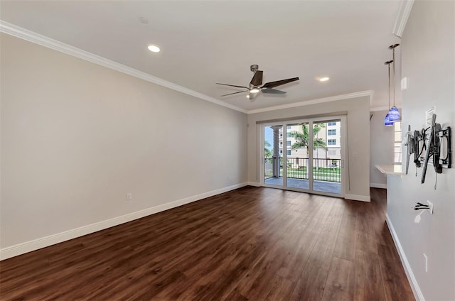 spare room with dark hardwood / wood-style floors, ceiling fan, and crown molding