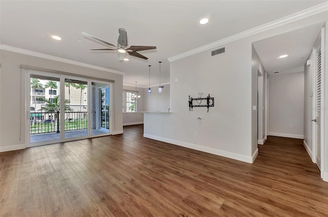 830 The Esplanade N Unit 203, Venice, FL 34285 - unfurnished living room with baseboards, wood finished floors, crown molding, ceiling fan, and a chandelier