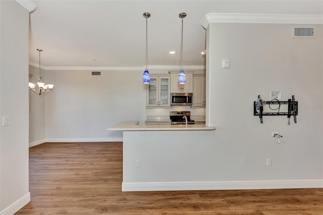 830 The Esplanade N Unit 203, Venice, FL 34285 - kitchen featuring stainless steel appliances, cream cabinets, light wood-style floors, baseboards, and glass insert cabinets