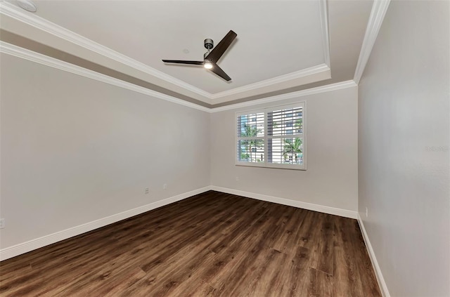 spare room with dark hardwood / wood-style floors, a raised ceiling, ceiling fan, and crown molding