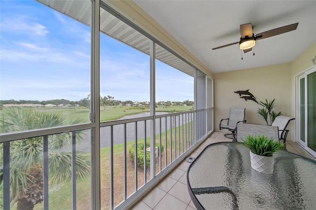 sunroom / solarium featuring a rural view and ceiling fan