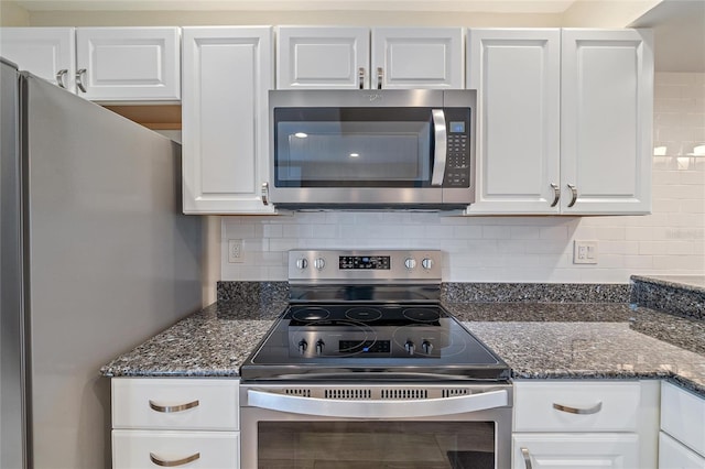 kitchen with white cabinets, appliances with stainless steel finishes, and tasteful backsplash