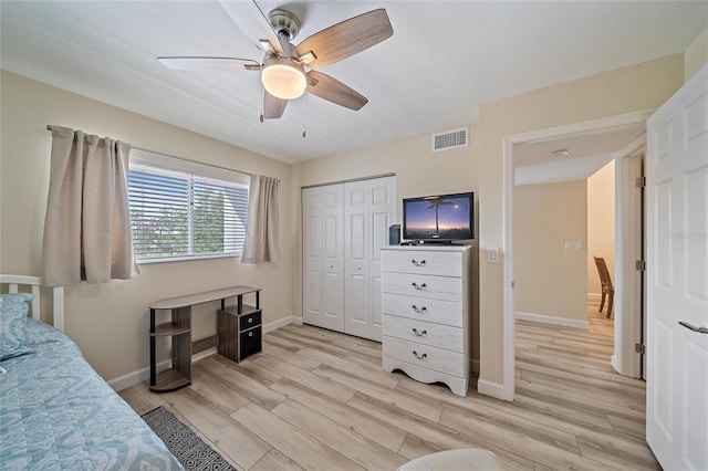 bedroom featuring a closet, light hardwood / wood-style flooring, and ceiling fan