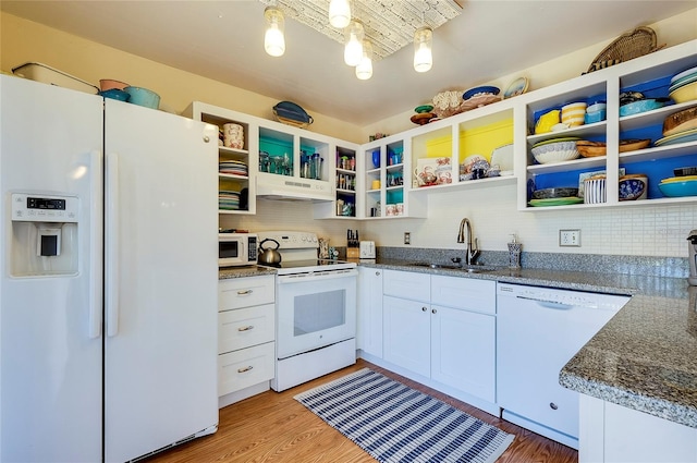 kitchen featuring sink, dark stone counters, light hardwood / wood-style floors, white appliances, and white cabinets