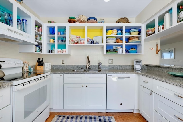 kitchen featuring white cabinetry, sink, light stone countertops, white appliances, and light wood-type flooring